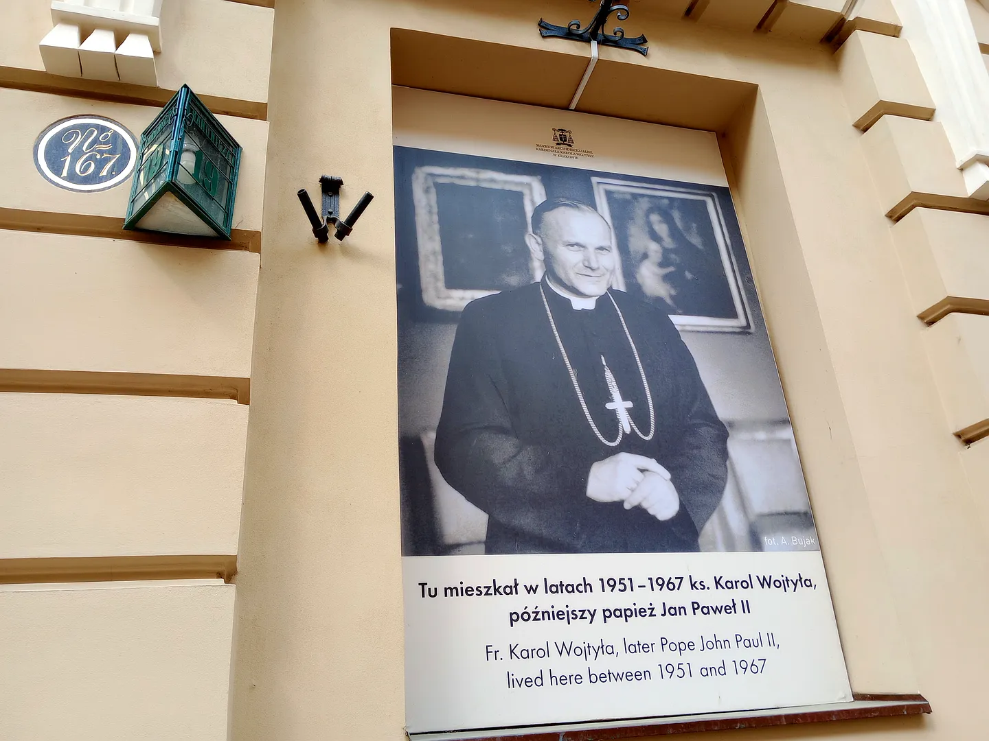 Photograph of Karol Wojtyła on the exterior of the Archdiocesan Museum in Kraków